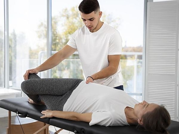 medium-shot-physiotherapist-helping-woman_Copy